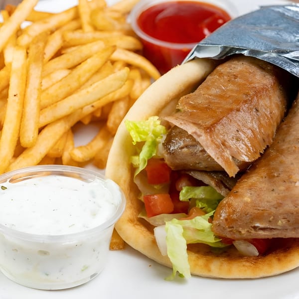 Dino's Greek & Italian Grill's gyro with fries, ketchup, and tzatziki sauce.